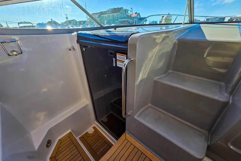  Yacht Photos Pics 2015 Sea Ray 310 Sundancer boat interior with stairs and wooden flooring.