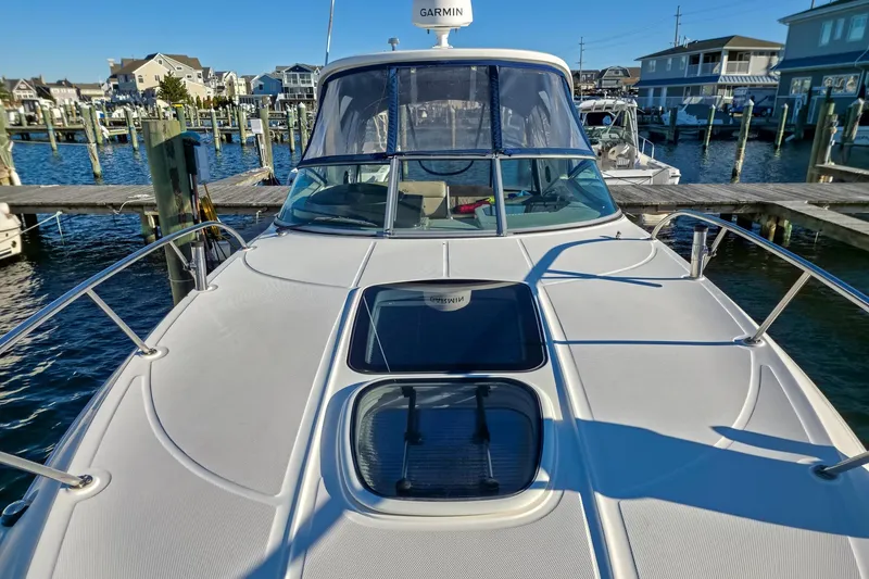  Yacht Photos Pics 2015 Sea Ray 310 Sundancer docked at marina, showcasing sleek design and spacious deck.
