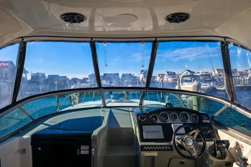  Yacht Photos Pics Interior view of 2015 Sea Ray 310 Sundancer boat cockpit with marina backdrop.
