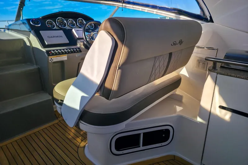  Yacht Photos Pics 2015 Sea Ray 310 Sundancer cockpit with Garmin navigation, luxurious seating, and modern controls.