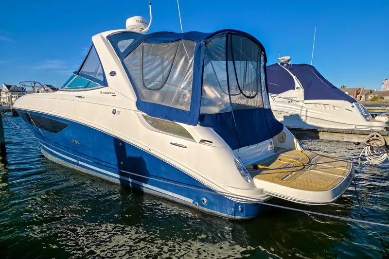  Yacht Photos Pics 2015 Sea Ray 310 Sundancer boat docked in marina, featuring blue and white exterior.