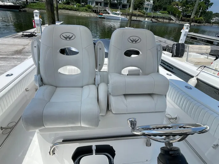  Yacht Photos Pics 2014 Southport 27 Center Console boat with dual white captain's chairs at the helm.