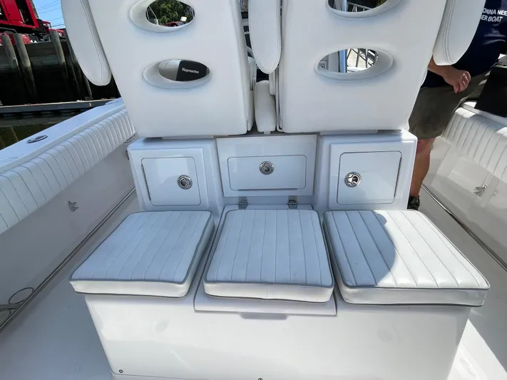  Yacht Photos Pics 2014 Southport 27 Center Console boat with white cushioned seating and storage compartments.
