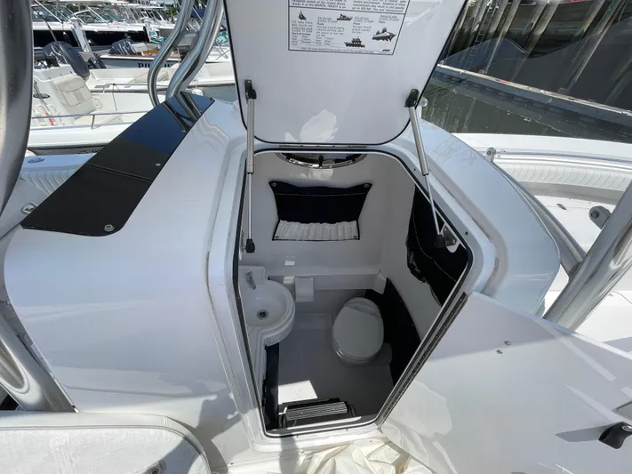  Yacht Photos Pics 2014 Southport 27 Center Console boat interior with open hatch and compact restroom.