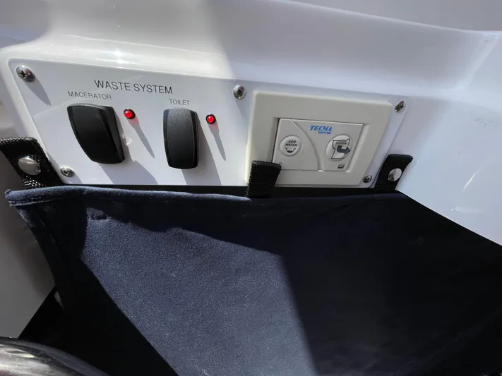  Yacht Photos Pics Control panel of 2014 Southport 27 Center Console waste system with switches and indicators.