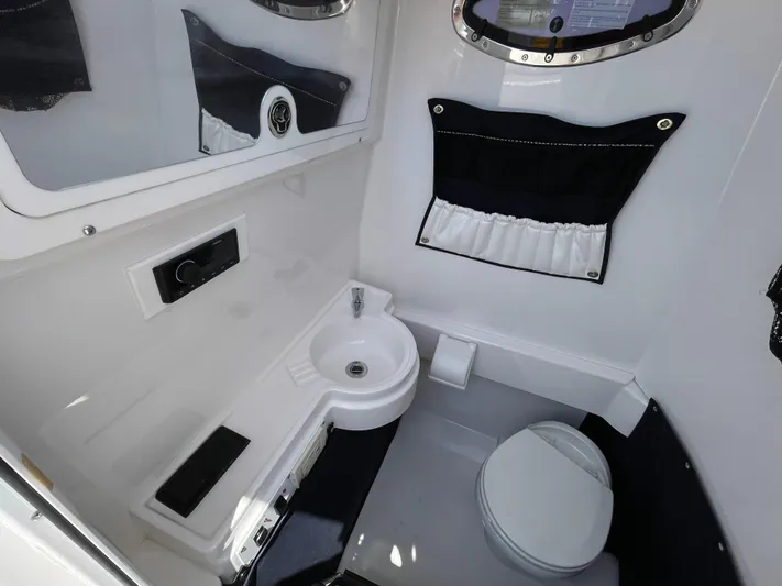  Yacht Photos Pics 2014 Southport 27 Center Console boat interior with sink and toilet.