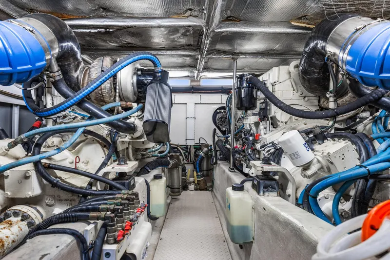 The Blue Fish Yacht Photos Pics Engine room of a 2007 Sea Ray 52 Sedan Bridge yacht, showcasing complex machinery and components.