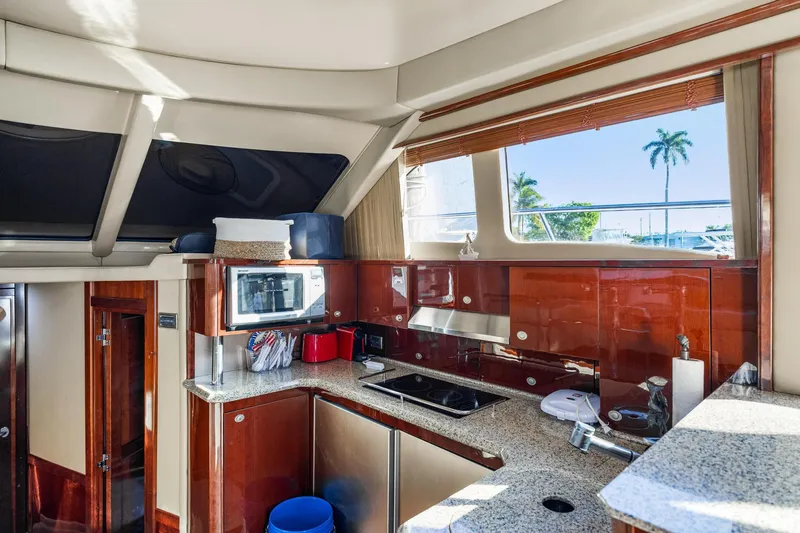 The Blue Fish Yacht Photos Pics Luxurious kitchen interior of 2007 Sea Ray 52 Sedan Bridge yacht with modern amenities.
