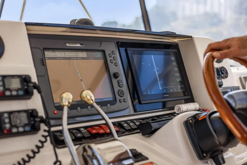 The Blue Fish Yacht Photos Pics 2007 Sea Ray 52 Sedan Bridge helm with navigation screens and controls.