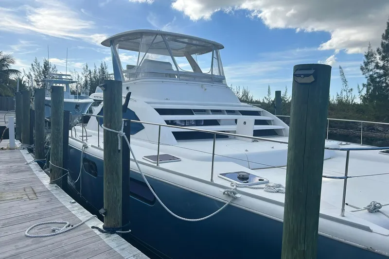 Shearwater Yacht Photos Pics 2011 Leopard 47 Powercat docked, featuring sleek design and spacious deck under a clear sky.
