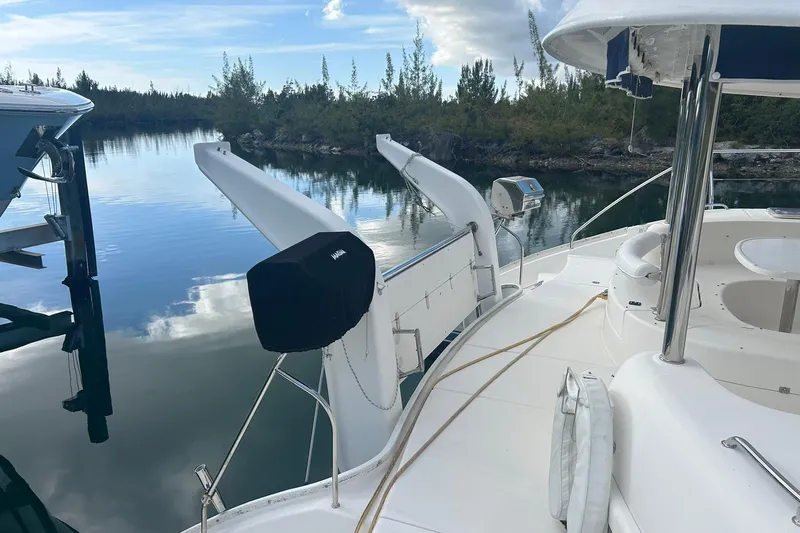 Shearwater Yacht Photos Pics 2011 Leopard 47 Powercat yacht docked in serene waters, surrounded by lush greenery.
