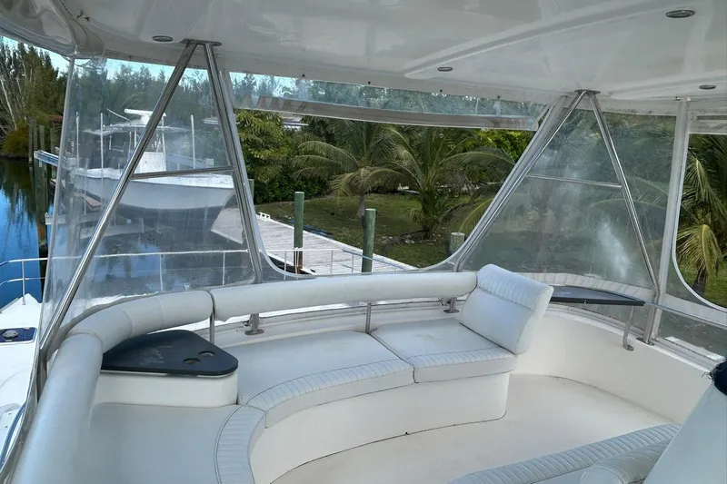 Shearwater Yacht Photos Pics 2011 Leopard 47 Powercat yacht interior with white seating and clear windows, docked near palm trees.