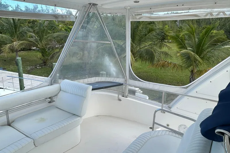 Shearwater Yacht Photos Pics Interior view of 2011 Leopard 47 Powercat with white seating and tropical backdrop.