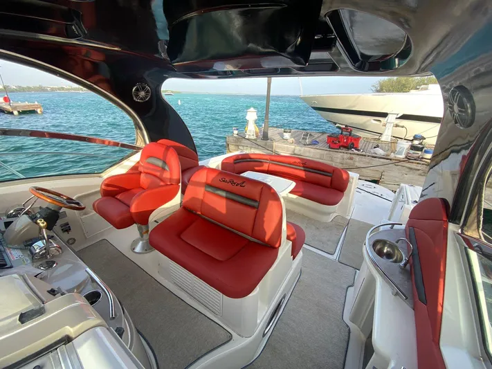 Red Scorpion Yacht Photos Pics Interior of 2007 Sea Ray 400 Sundancer with red seating, docked by the water.