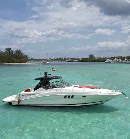 Red Scorpion Yacht Photos Pics 2007 Sea Ray 400 Sundancer yacht on turquoise waters under a partly cloudy sky.