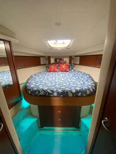 Red Scorpion Yacht Photos Pics 2007 Sea Ray 400 Sundancer cabin with bed, skylight, and blue-themed decor.