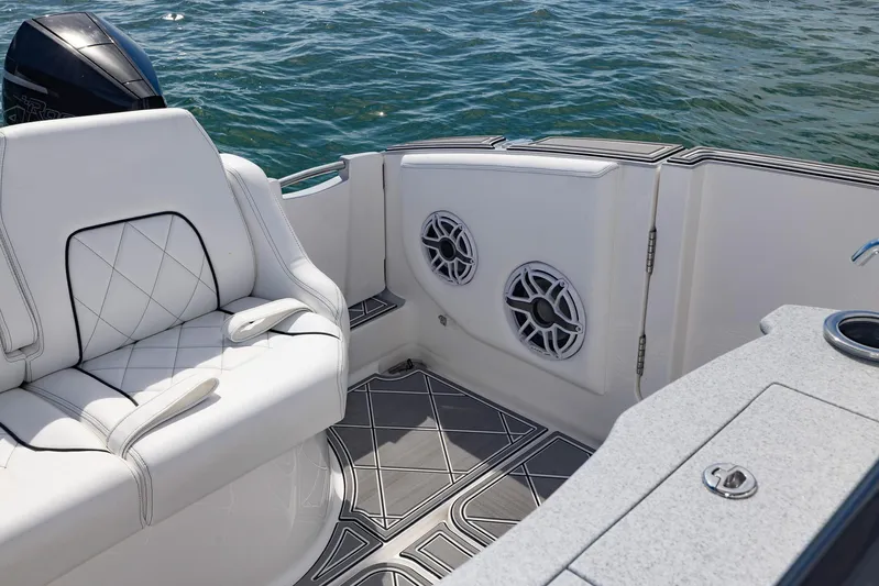  Yacht Photos Pics 2024 Deep Impact 399 Sport boat interior with white seating and marine speakers.