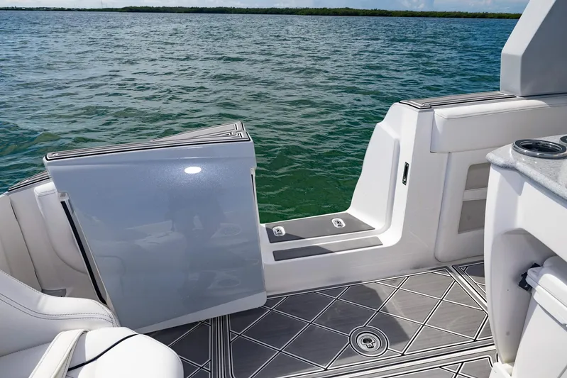  Yacht Photos Pics 2024 Deep Impact 399 Sport boat interior with open door, overlooking calm water.
