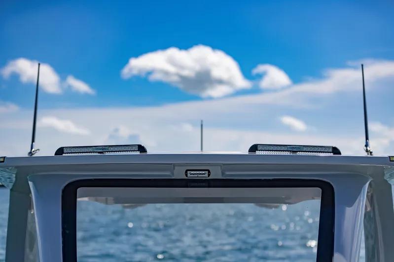  Yacht Photos Pics 2024 Deep Impact 399 Sport boat against a clear blue sky and ocean backdrop.