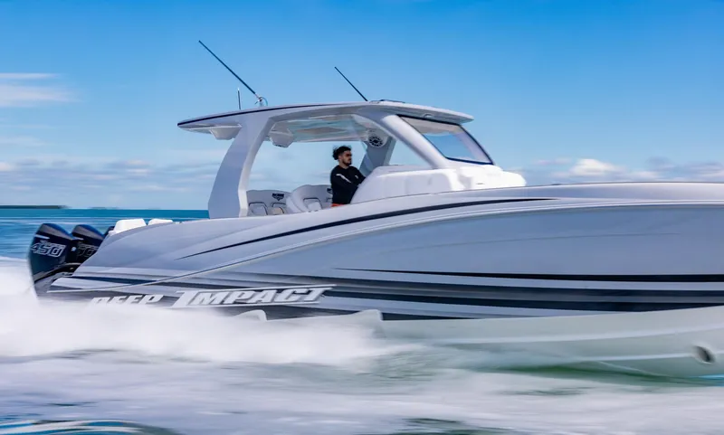  Yacht Photos Pics 2024 Deep Impact 399 Sport boat cruising on open water, side view.