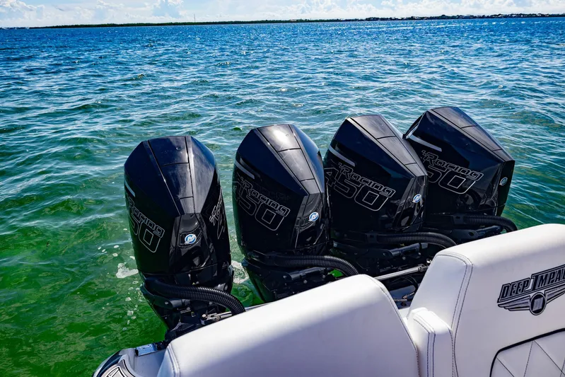  Yacht Photos Pics 2024 Deep Impact 399 Sport boat with four powerful outboard engines on the water.