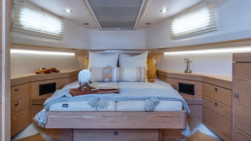 Elise Yacht Photos Pics Luxurious cabin interior of 2017 Fjord 40 Open yacht with cozy bedding and elegant decor.