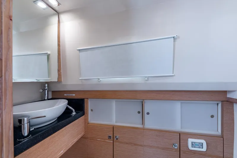 Elise Yacht Photos Pics Modern bathroom interior on 2017 Fjord 40 Open yacht, featuring sleek sink and wooden cabinetry.