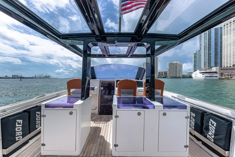 Elise Yacht Photos Pics 2017 Fjord 40 Open yacht interior with city skyline and American flag in the background.