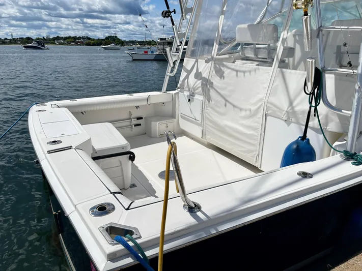 Wanda Lee Yacht Photos Pics 1999 Cabo 31 Express boat docked, featuring spacious deck and seating area.
