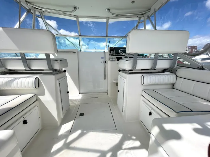 Wanda Lee Yacht Photos Pics 1999 Cabo 31 Express boat interior with white seating and clear blue sky.