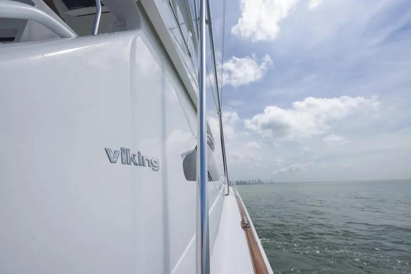 Seven Seas Yacht Photos Pics 2024 Viking 58 Convertible yacht cruising on open water under a cloudy sky.