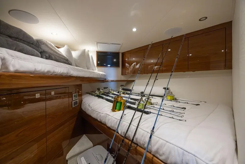 Seven Seas Yacht Photos Pics 2024 Viking 58 Convertible cabin with fishing rods and cozy bedding.