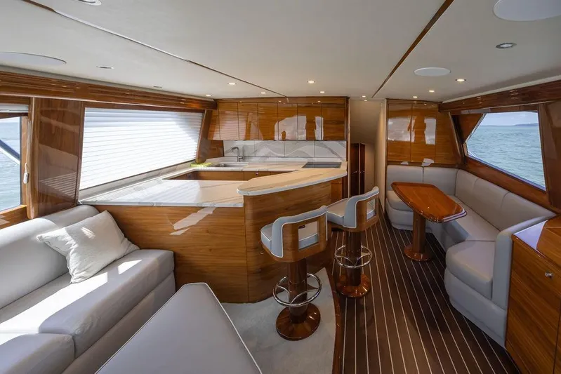 Seven Seas Yacht Photos Pics Luxurious interior of 2024 Viking 58 Convertible yacht with elegant wood finishes and modern seating.