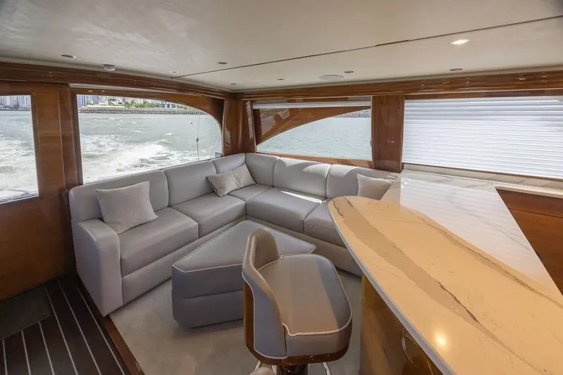 Seven Seas Yacht Photos Pics Luxurious interior of 2024 Viking 58 Convertible yacht with elegant seating and panoramic windows.