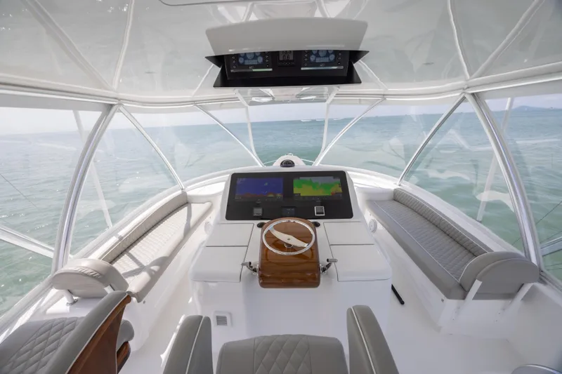 Seven Seas Yacht Photos Pics 2024 Viking 58 Convertible yacht helm with modern navigation displays and panoramic ocean view.