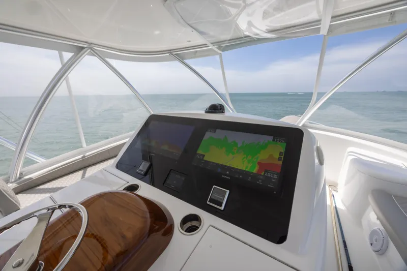 Seven Seas Yacht Photos Pics 2024 Viking 58 Convertible yacht helm with advanced navigation displays, overlooking the ocean.