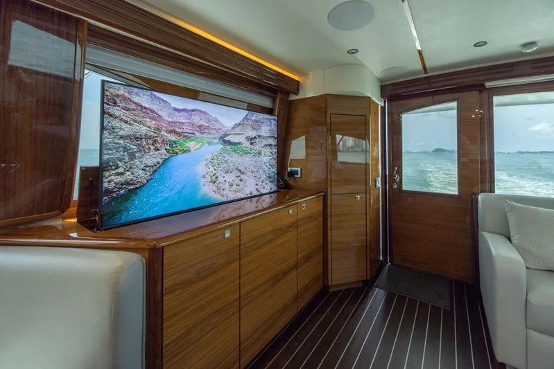 Seven Seas Yacht Photos Pics Luxurious interior of 2024 Viking 58 Convertible yacht with scenic TV display.