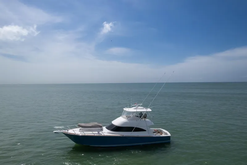 Seven Seas Yacht Photos Pics 2024 Viking 58 Convertible yacht on calm ocean under clear blue sky.