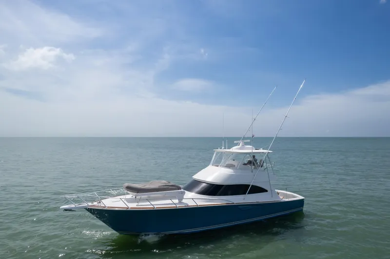 Seven Seas Yacht Photos Pics 2024 Viking 58 Convertible yacht on calm ocean under clear blue sky.