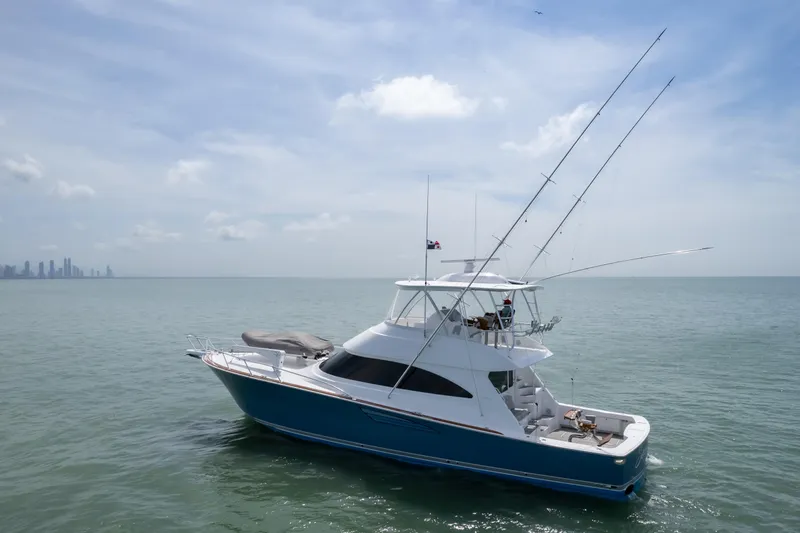 Seven Seas Yacht Photos Pics 2024 Viking 58 Convertible yacht cruising on calm ocean waters under a clear sky.