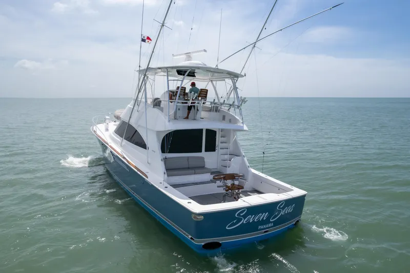 Seven Seas Yacht Photos Pics 2024 Viking 58 Convertible yacht cruising on open water, rear view.