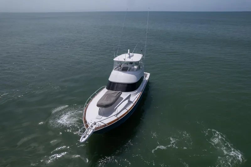 Seven Seas Yacht Photos Pics 2024 Viking 58 Convertible yacht cruising on open sea.