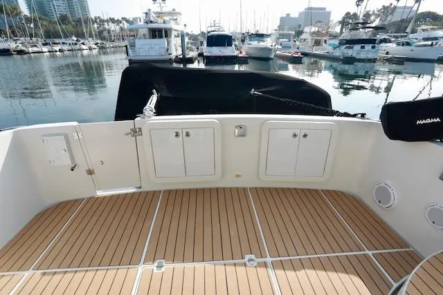 Four Us Yacht Photos Pics 2006 Carver 42 Super Sport yacht deck with marina view, featuring teak flooring.