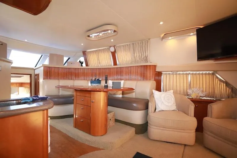 Four Us Yacht Photos Pics Luxurious interior of 2006 Carver 42 Super Sport yacht with elegant seating and dining area.