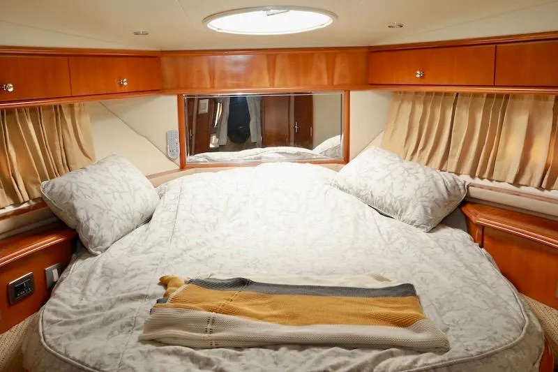 Four Us Yacht Photos Pics Luxurious bedroom interior of 2006 Carver 42 Super Sport yacht with elegant bedding.
