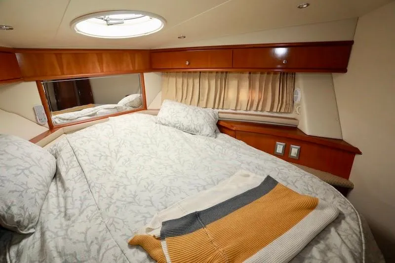 Four Us Yacht Photos Pics Luxurious cabin interior of 2006 Carver 42 Super Sport yacht with cozy bedding.