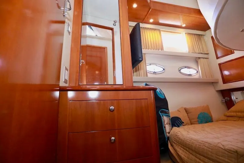 Four Us Yacht Photos Pics Interior of 2006 Carver 42 Super Sport yacht with wood cabinetry and cozy bedding.