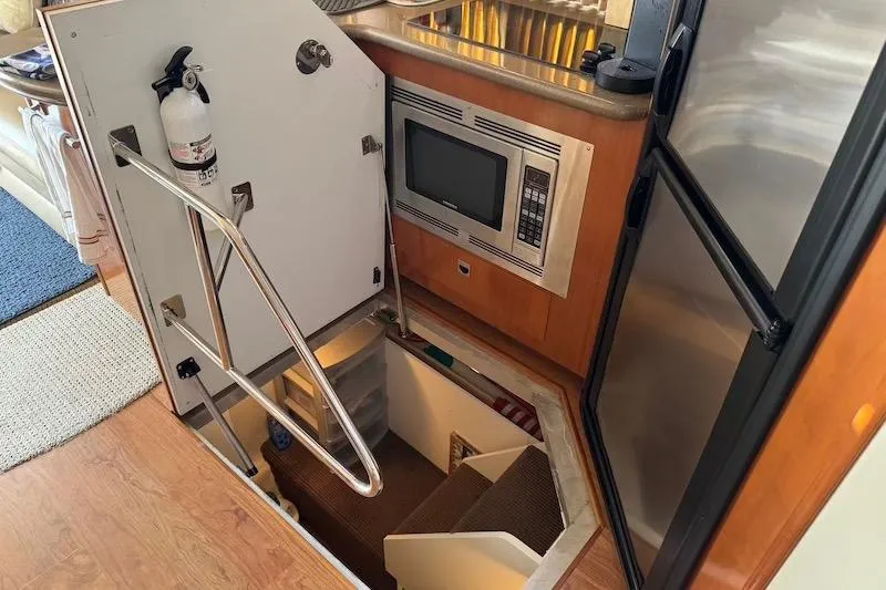 Four Us Yacht Photos Pics Interior of 2006 Carver 42 Super Sport yacht with kitchen and stairway access.