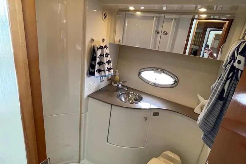 Four Us Yacht Photos Pics Bathroom interior of 2006 Carver 42 Super Sport yacht with sink and porthole window.