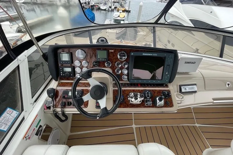 Four Us Yacht Photos Pics Helm of 2006 Carver 42 Super Sport yacht with navigation instruments and steering wheel.